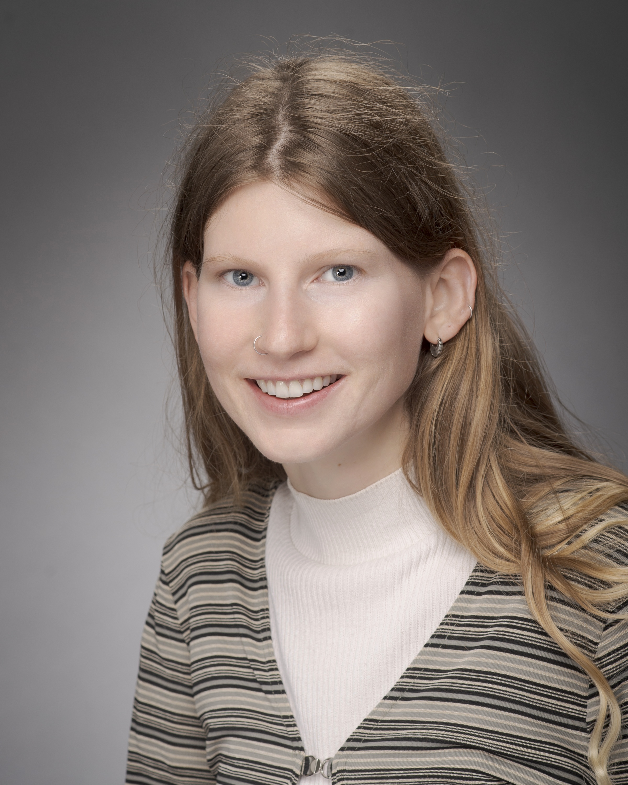 woman with light brown hair smiling