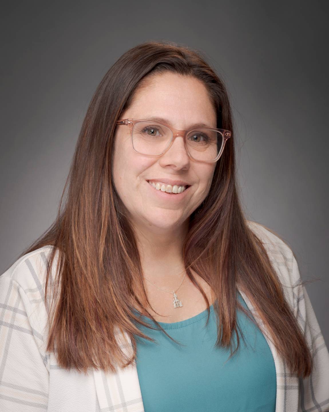 smiling woman with dark hair and glasses